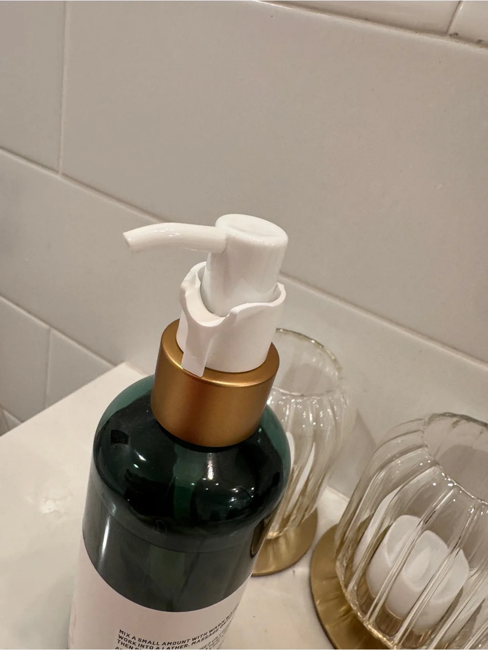 Biossance green and gold pump facial cleanser